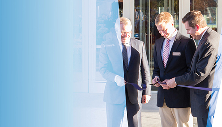 white male student at ribbon cutting with blue graphic treatment white male student at ribbon cutting with blue graphic treatment