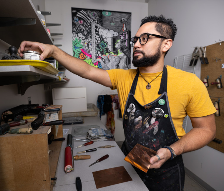 Reinaldo Gil Zambrano, M.F.A., of the Gonzaga University Art Department working on a print.