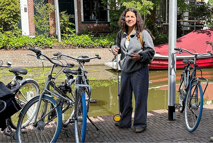 Woman standing by several bicycles