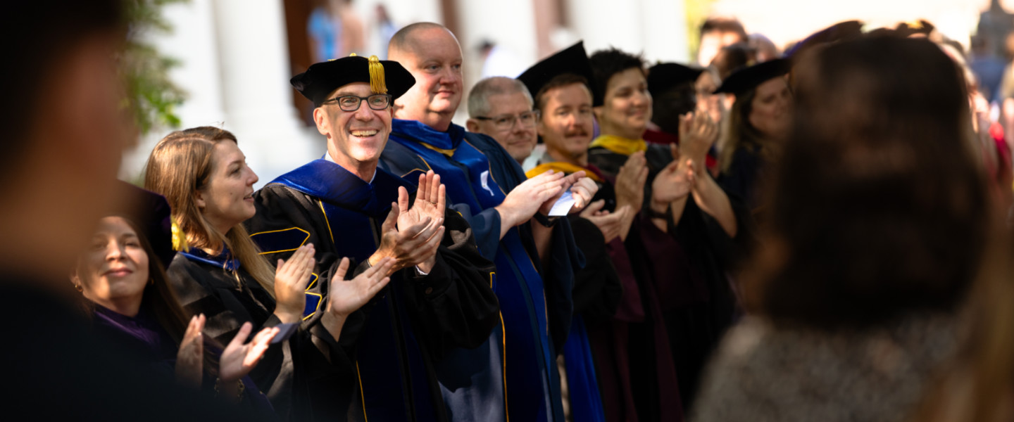 Gonzaga University Faculty in a line clapping for new first year students as they walk to their first convocation.
