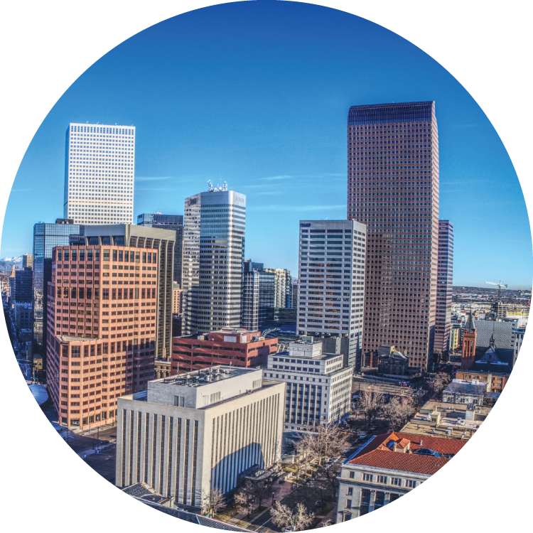 The downtown Denver skyline reaches up into a bright blue, cloudless sky. The downtown Denver skyline reaches up into a bright blue, cloudless sky.