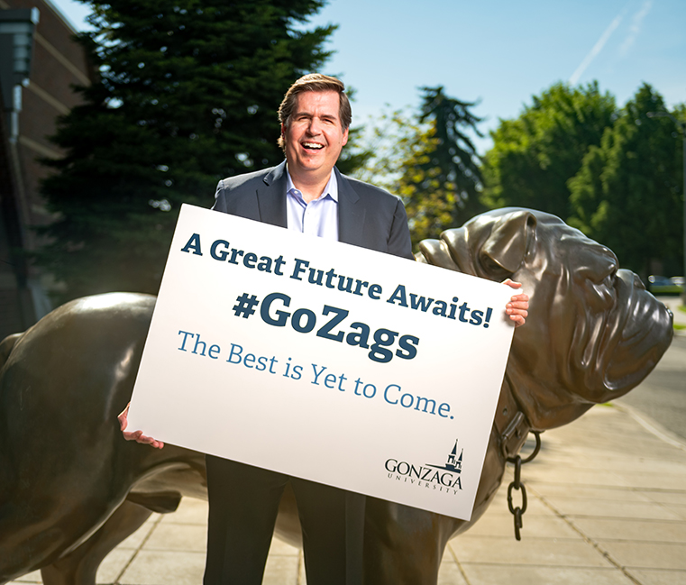 Former Gonzaga President Thayne McCulloh holds a sign reading 