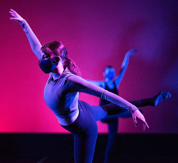 Two dancers pose on stage. Two dancers pose on stage.