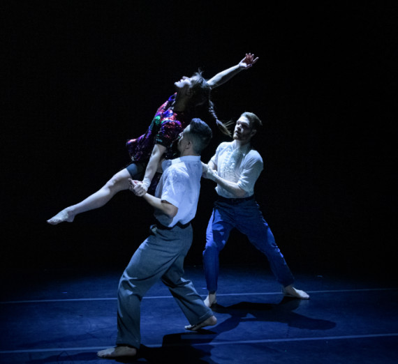 Two dancers holding a third in the air. Two dancers holding a third in the air.