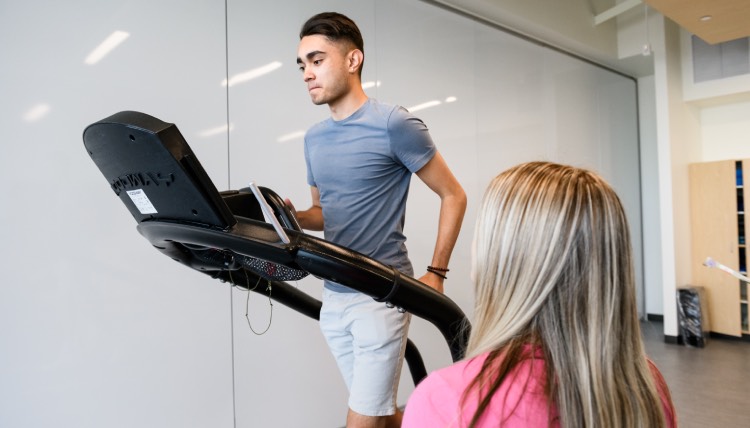 Student running on a treadmill in lab Student running on a treadmill in lab