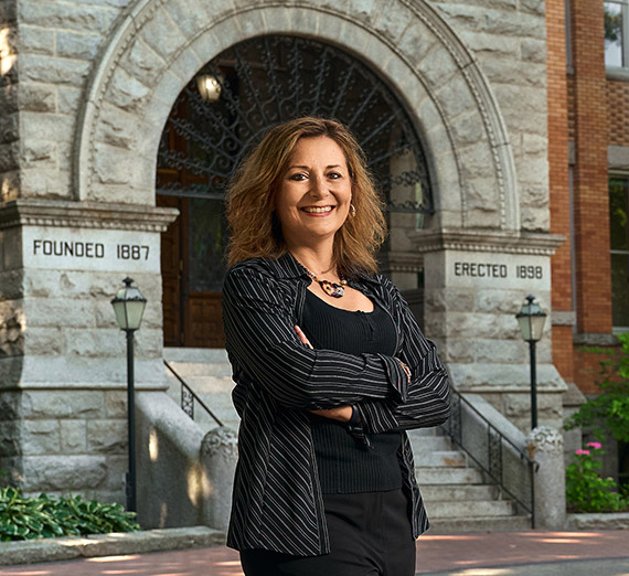 President Passerini stands in front of Gonzaga's College Hall.