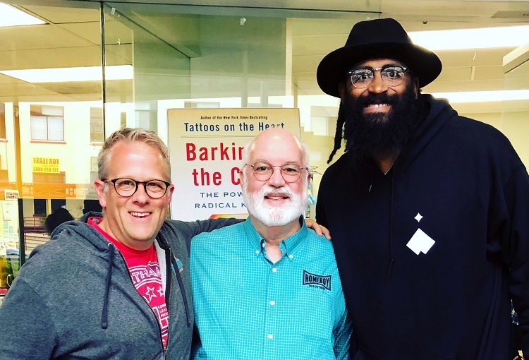 Josh Armstrong, Father Greg Boyle, and Ronny Turiaf smile for a photo. Josh Armstrong, Father Greg Boyle, and Ronny Turiaf smile for a photo.