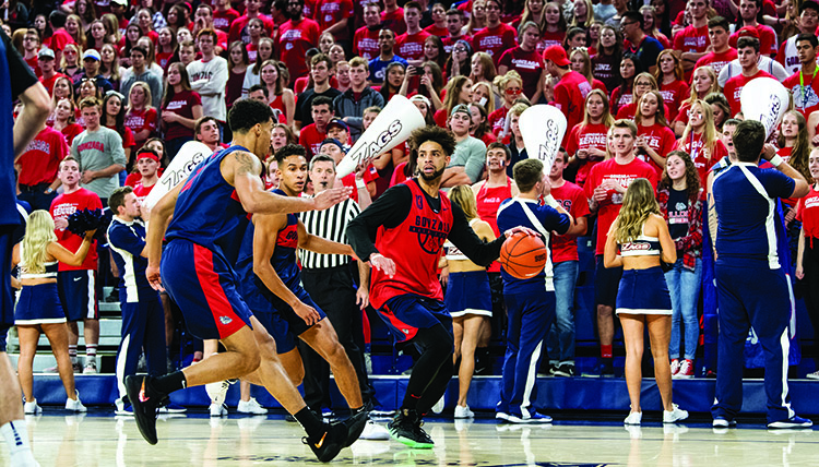 Two players compete for the ball during a basketball scrimmage. Two players compete for the ball during a basketball scrimmage.