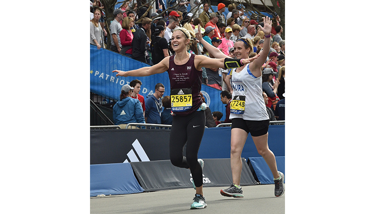 Lauren Zeutenhorst crossing finish line at Boston Marathon, arms spread wide Lauren Zeutenhorst crossing finish line at Boston Marathon, arms spread wide