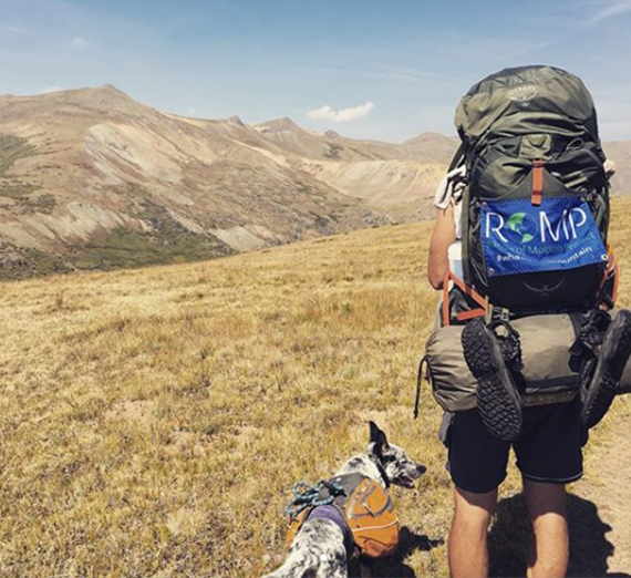 Aska and Williams hike through Colorado displaying the ROMP nonprofit logo.
