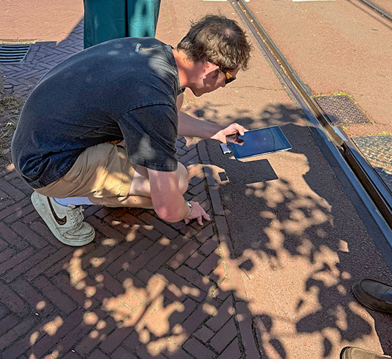 student measures the ground with an iPad