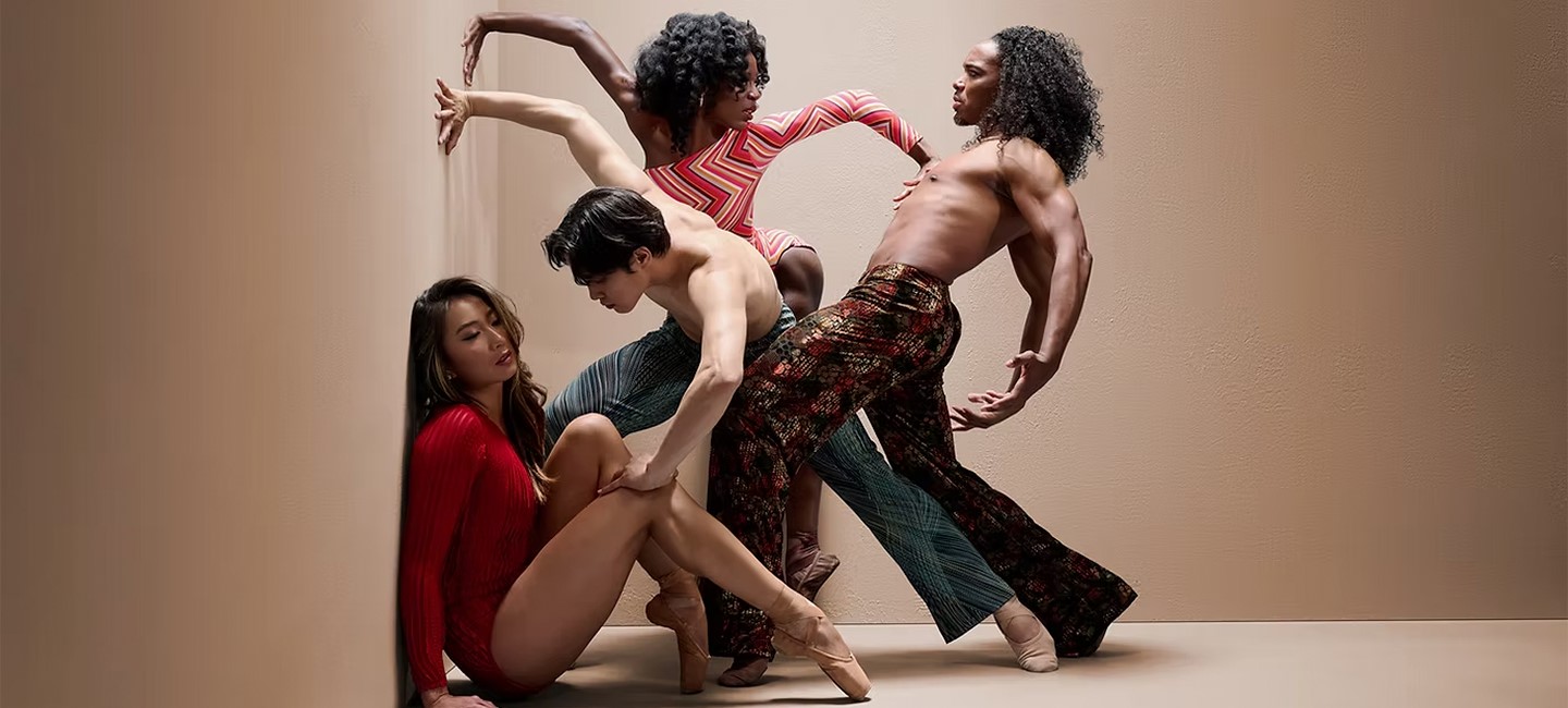 Dancers posed together against a neutral background.