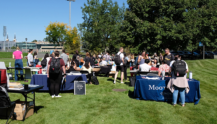 Students gather on the lawn South of the Law School to talk about different clubs and organizations they can be involved in. Students gather on the lawn South of the Law School to talk about different clubs and organizations they can be involved in.