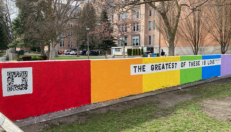 Rainbow painted wall with the phrase, 