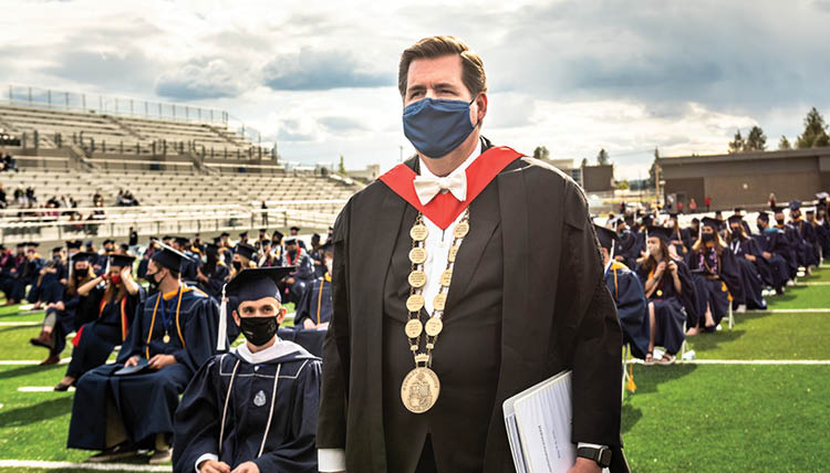 President McCulloh stands beside seated students at Gonzaga's commencement ceremony. President McCulloh stands beside seated students at Gonzaga's commencement ceremony.