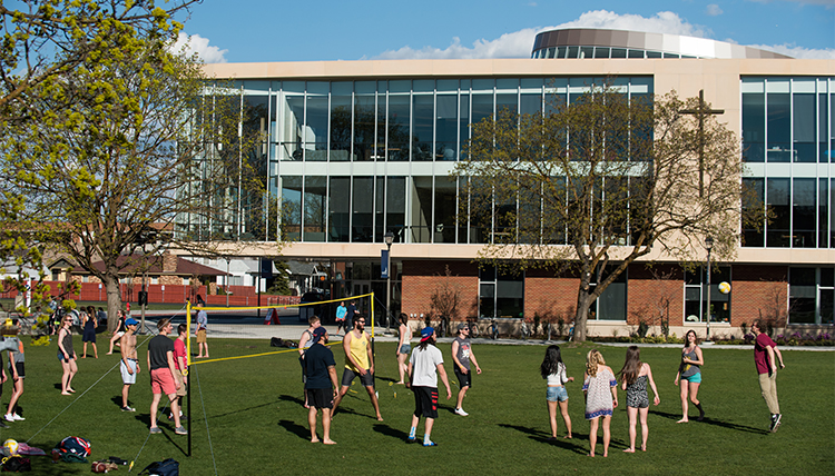 A group of students plays pickup volleyball on the quad on campus on a spring afternoon. A group of students plays pickup volleyball on the quad on campus on a spring afternoon.