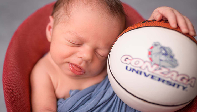 A baby poses with a GU basketball A baby poses with a GU basketball