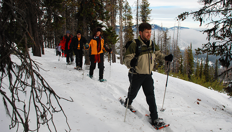A group of people snowshoe on a trail along a ridge at Mt. Spokane State Park. A group of people snowshoe on a trail along a ridge at Mt. Spokane State Park.