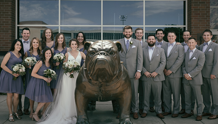 large group with wedding couple around Bulldog statue large group with wedding couple around Bulldog statue