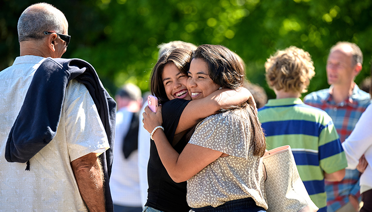 body-WelcomeWeekendHug A woman and older woman hugging