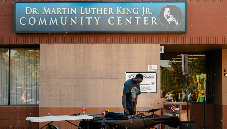 A DJ playing music underneath a banner saying Martin Luther King Jr 
