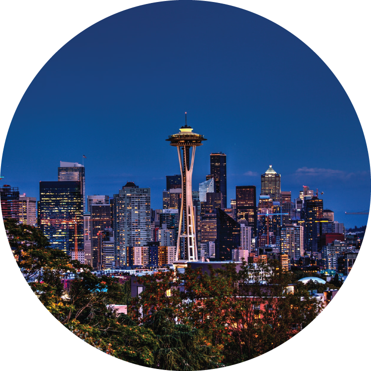 Against a deep blue, twilight sky, the Space Needle and city skyline sparkles with light. Against a deep blue, twilight sky, the Space Needle and city skyline sparkles with light.