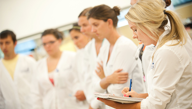 Undergraduate nursing student taking notes in the Sim Lab. Undergraduate nursing student taking notes in the Sim Lab.