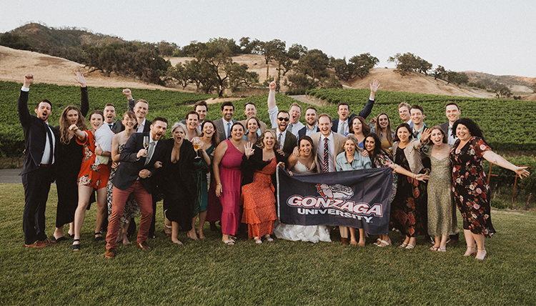 large wedding party outdoors with GU flag large wedding party outdoors with GU flag