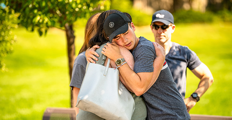A mother and son embrace and say goodbye during Welcome Weekend A mother and son embrace and say goodbye during Welcome Weekend