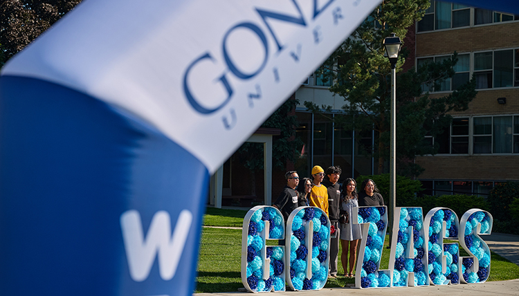 A family poses by a Go Zags sign
