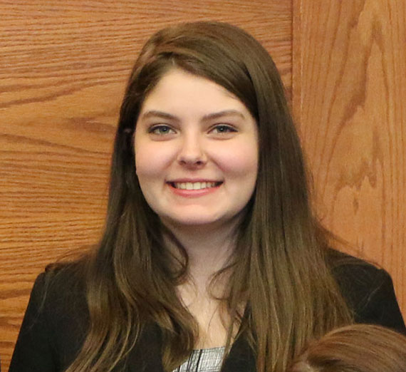 Elli Williams stands in front of a mock trial court room. Elli Williams stands in front of a mock trial court room.