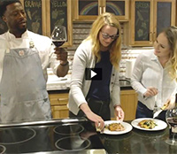 Three people enjoy a wine and food pairing. Three people enjoy a wine and food pairing.