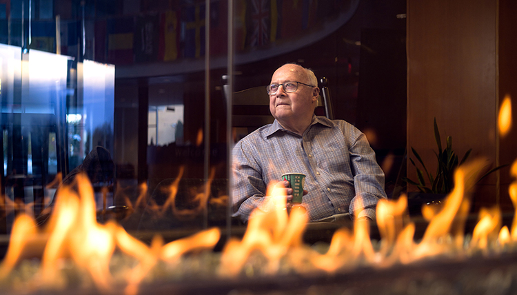 professor drinks coffee by fireplace professor drinks coffee by fireplace