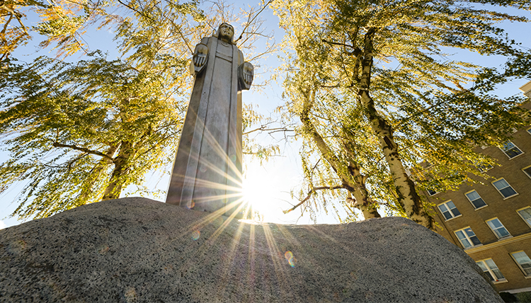aluminum jesus sculpture backlit by sun aluminum jesus sculpture backlit by sun