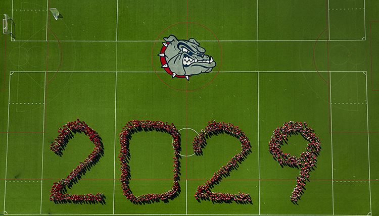 student spelling out 2029 on a green field student spelling out 2029 on a green field