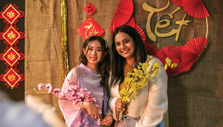 two women in front of a colorful Vietnamese Tet background two women in front of a colorful Vietnamese Tet background