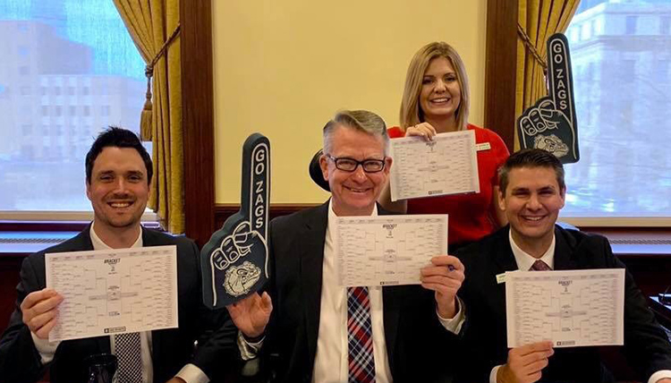 three alumni in ID Governors office show their March Madness brackets and Go Zags materials three alumni in ID Governors office show their March Madness brackets and Go Zags materials