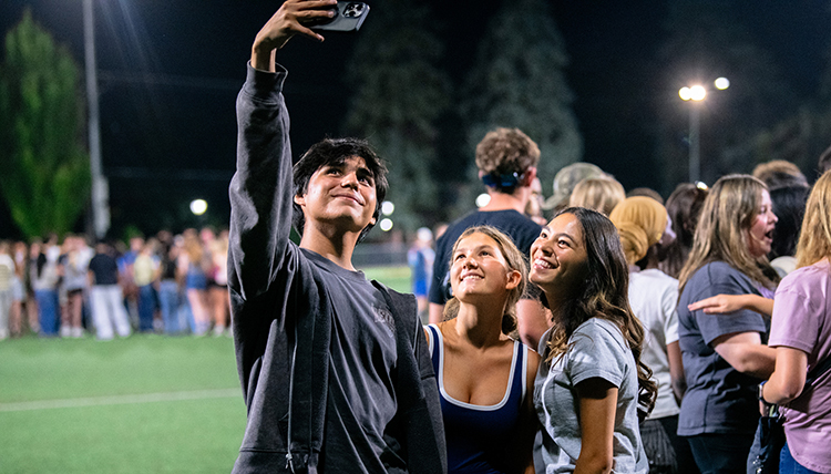 a man and two women take a selfie