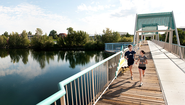 Students running on bridge across Spokane River Students running on bridge across Spokane River