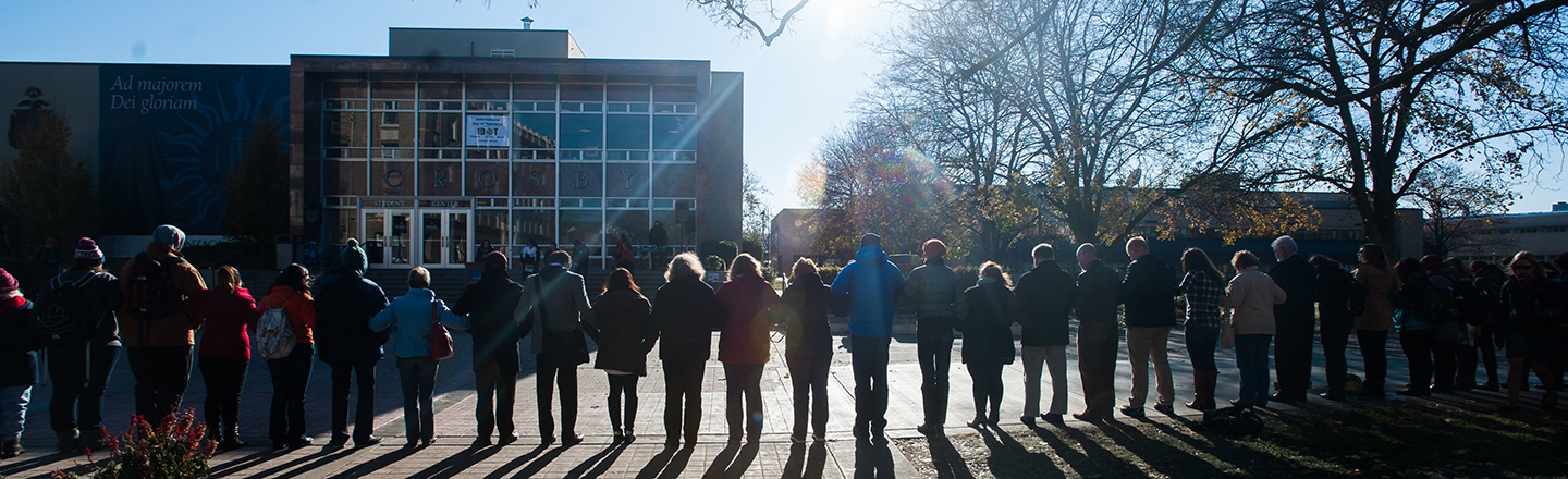 Silhouette of students locking arms