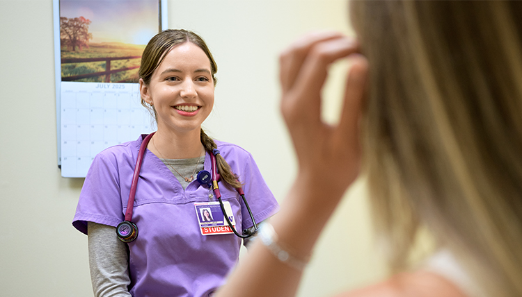 female medical student visits with patient in clinic female medical student visits with patient in clinic