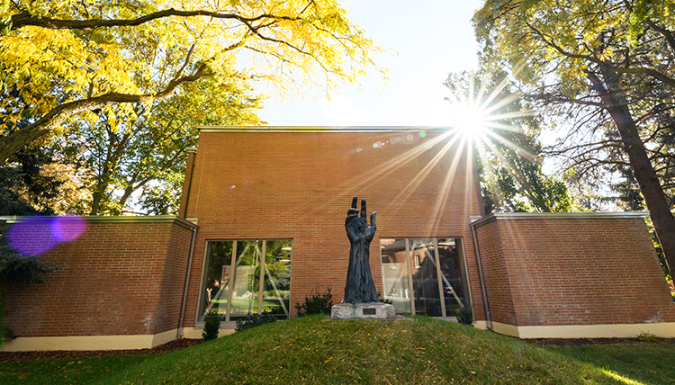 building with sculpture of hand of christ