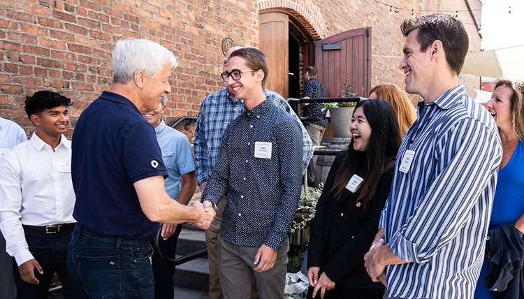JPMorgan Chase CEO Jamie Dimon and Gonzaga student Kaden McCullough shake hands while other GU students stand nearby JPMorgan Chase CEO Jamie Dimon and Gonzaga student Kaden McCullough shake hands while other GU students stand nearby