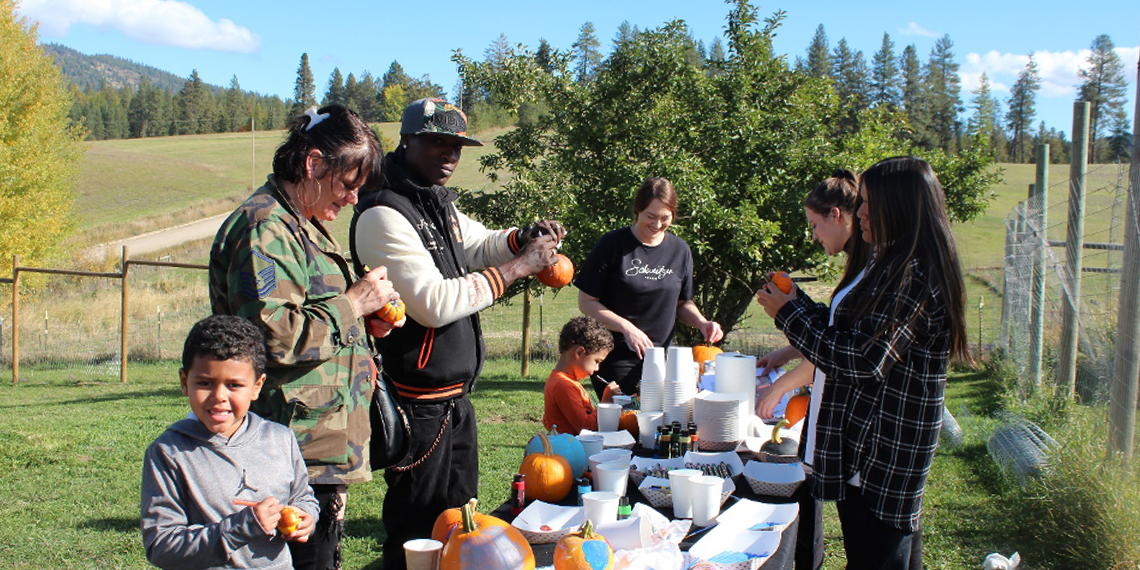 Family gathering enjoying lunch with activities at a farm