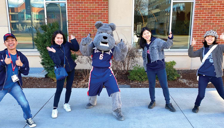 Spike the bulldog and students give thumbs up Spike the bulldog and students give thumbs up