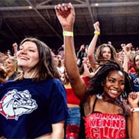 Two Gonzaga students cheering in a crowd. Two Gonzaga students cheering in a crowd.