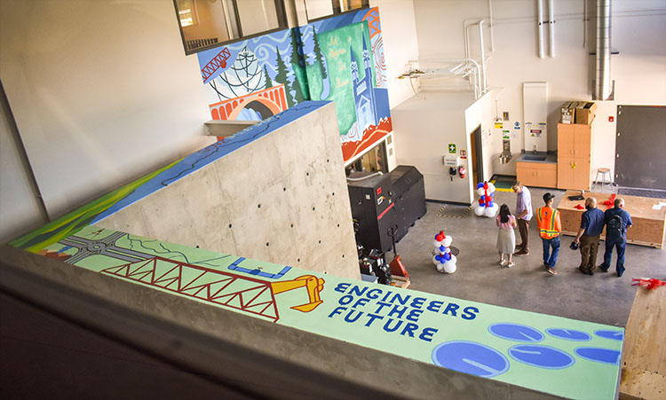 Several flat surfaces painted in sea green with images of a bridge, a river, and the spires of the church at Gonzaga's campus with the words Engineers of the future