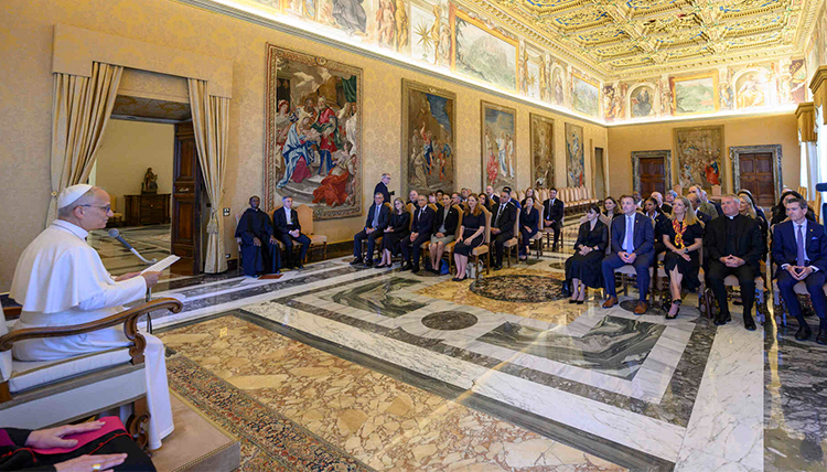 Pope Leo speaks to a group of seated people