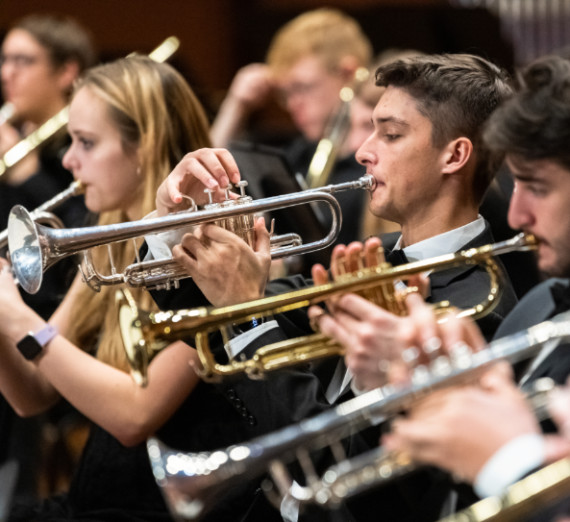 Gonzaga University band students playing the trumpet at a concert.