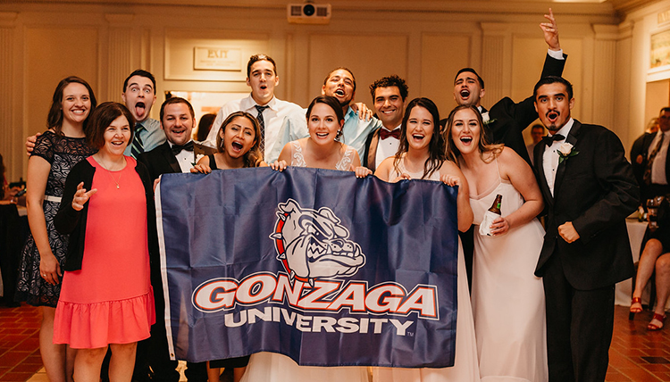 family gather around couple with GU flag family gather around couple with GU flag